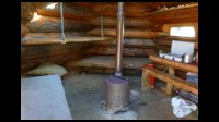08h37-Cozy-hut-2.beds+stove.jpg